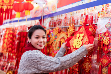 A young woman strolls through the flower street during Chinese New Year