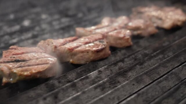 Tender filet mignon steaks sizzling on the grill, capturing the juicy texture, perfect grill marks, and smoky aroma of this gourmet meat preparation