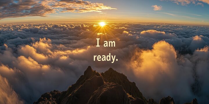 Motivationsspruch "I am ready" mit Blick auf Sonnenaufgang &uuml;ber den Wolken