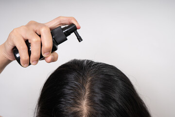 woman applying hair serum , hair care treatment and concept, strengthening and growth of hair