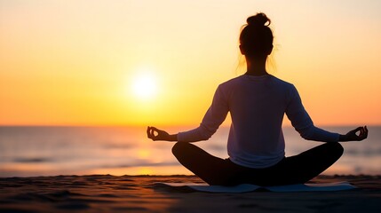 A person meditating on the beach at sunset, embodying peace and tranquility.