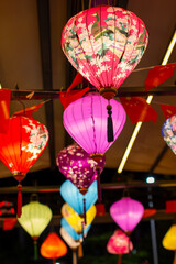 colorful paper lanterns hanging from a ceiling with a pink paper lantern © sharklets