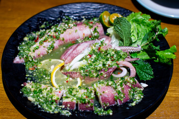 a bowl of food with a slice of lemon and a slice of lemon.