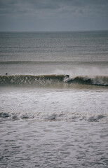 Fototapeta premium Person surfing on a huge wave