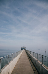 Obraz premium wide view of the road of a bridge on the sea attached to the harbour