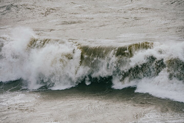 Close up shot of the High tide waves in the sea and water splashing everywhere