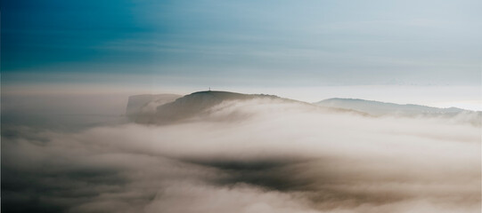 Fog and clouds over the mountains of the island in the sea