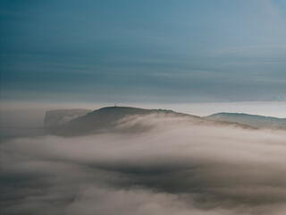 Fog and clouds over the mountains of the island in the sea