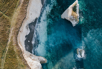 Top view of the sea and the coast of an island and dark blue all transparent water