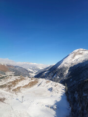 Glacier in the snow covered mountains on a sunny day. 