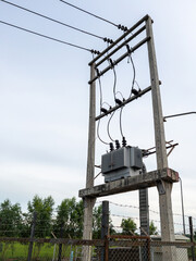 The electrical transformer installed on the concrete pole.