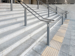 The concrete stairs with stainless steel handrails.