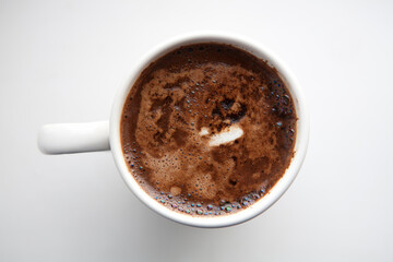 white cup with aromatic coffee on white background