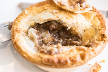 Golden Brown Australian Beef Pie on a White Plate