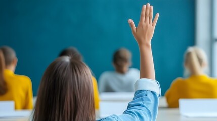 Student raising hand in a classroom, seeking to answer or ask a question.
