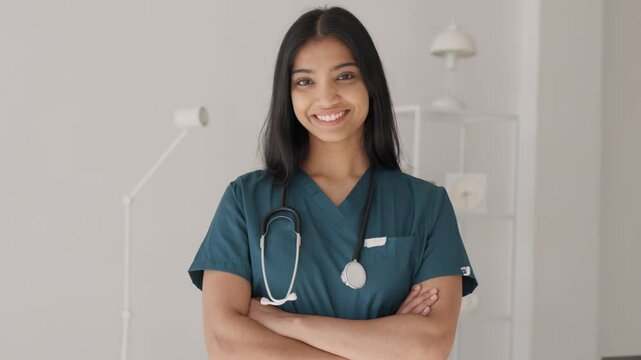 Portrait of smiling hispanic latin female doctor in medical Uniform standing in hospital corridor looking at camera with stethoscope. Health care and medical concept. Indian Medical worker 