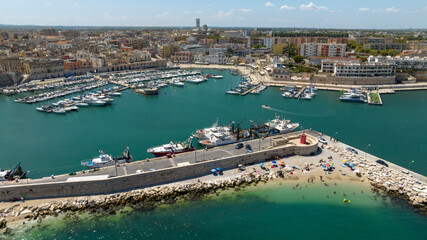 Fototapeta premium Aerial view of the port of Bisceglie, in Puglia, Italy. It is a small marina with many boats anchored located on the Mediterranean Sea.