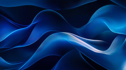 Fototapeta premium Smooth flowing dark blue fabric draping elegantly in soft light, showcasing texture and depth