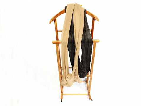 2 black pantyhose pairs on hold clothes