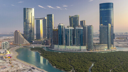 Naklejka premium Buildings on Al Reem island in Abu Dhabi day to night timelapse from above.