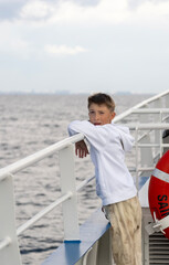 boy on a ferry on open water