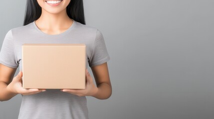 Professional woman presenting blank product box studio setting business promotion minimalistic design eye-level view branding concept