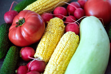Variety of fresh vegetables on a dark background. Vegetables set. Vegetables background. Healthy food.	