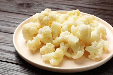 Tasty cooked cauliflower on wooden table, closeup