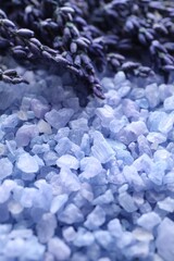 Natural sea salt and lavender flowers as background, closeup