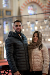 Close-up of tourist couple inside Istanbul mosque sightseeing