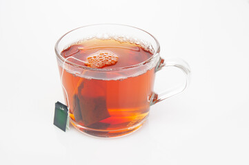 Glass cup with tea bag close up on a white background