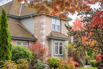 Fragment of  luxury house in fall with green trees and nice landscape in Vancouver, Canada, North America. Day time on November 2024.