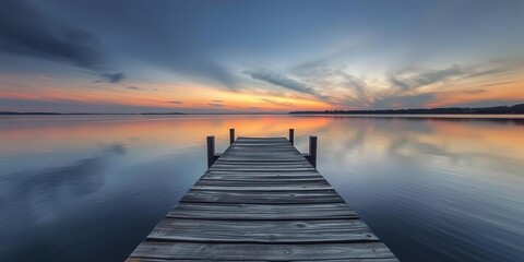 Obraz premium Abandoned wooden dock on a quiet lake at sunset, golden hour, peaceful