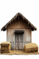 Wooden hut with thatched roof and hay bales.