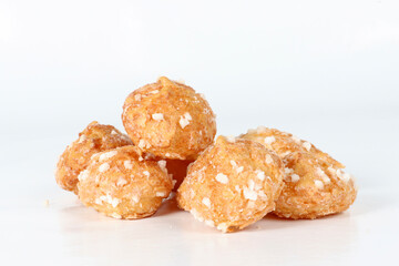 Chouquettes on a white background, small French choux pastries topped with pearl sugar