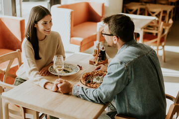 A joyful dinner date with delicious dishes and laughter in a cozy restaurant setting