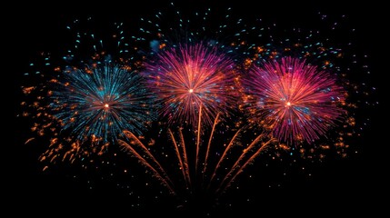 Naklejka premium Multiple fireworks bursting in vibrant colors against a dark sky, creating an awe-inspiring display