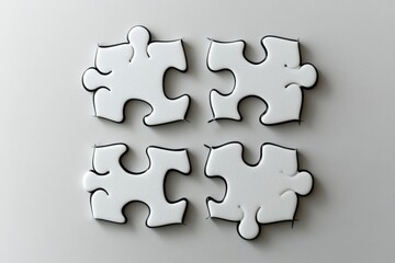 Obraz premium Black and white outline of four puzzle pieces fitting together in a minimalist grid layout