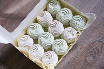 white and green vanilla marshmallows packaged in a white holiday box