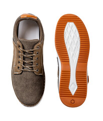 Khaki canvas shoe and its orange white sole cutout. New brown textile sneakers with lacing and white soles isolated on a white background. Shoes for walking and running.