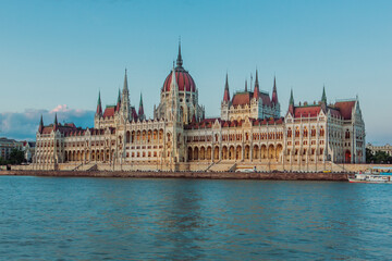 Fototapeta premium Majestic Hungarian Parliament Building with the Danube River in the Foreground: Iconic Views of Budapest's Historic Landmark