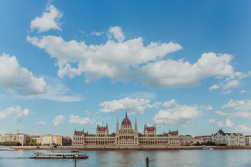 Fototapeta premium Majestic Hungarian Parliament Building with the Danube River in the Foreground: Iconic Views of Budapest's Historic Landmark