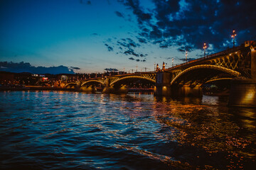 Margit Bridge (hid) during dusk - photo taken from the boat on river Danube