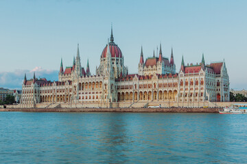 Fototapeta premium Majestic Hungarian Parliament Building with the Danube River in the Foreground: Iconic Views of Budapest's Historic Landmark