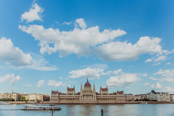 Fototapeta premium Majestic Hungarian Parliament Building with the Danube River in the Foreground: Iconic Views of Budapest's Historic Landmark