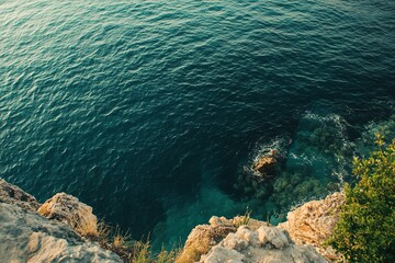 Fototapeta premium Explore the tranquil beauty of ocean water from a rocky cliffside perspective