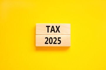 Naklejka premium Planning tax 2025 new year symbol. Concept words Tax 2025 on beautiful wooden blocks. Beautiful yellow background. Business tax 2025 new year concept. Copy space.