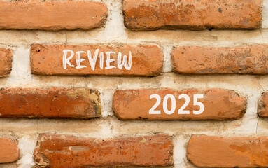 Planning review 2025 new year symbol. Concept words Review 2025 on beautiful brown brick wall. Beautiful brown brick wall background. Business review 2025 new year concept. Copy space.