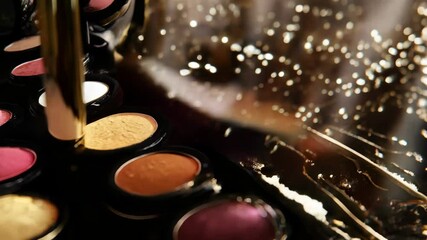 Gold makeup brush is picking up gold eyeshadow from a palette of colorful eyeshadows. The palette is reflected in a mirror with a bokeh effect - Powered by Adobe