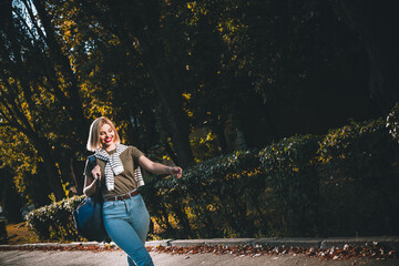 Photo of attractive young cheerful lady going university wear khaki garment tied shoulders sweater...